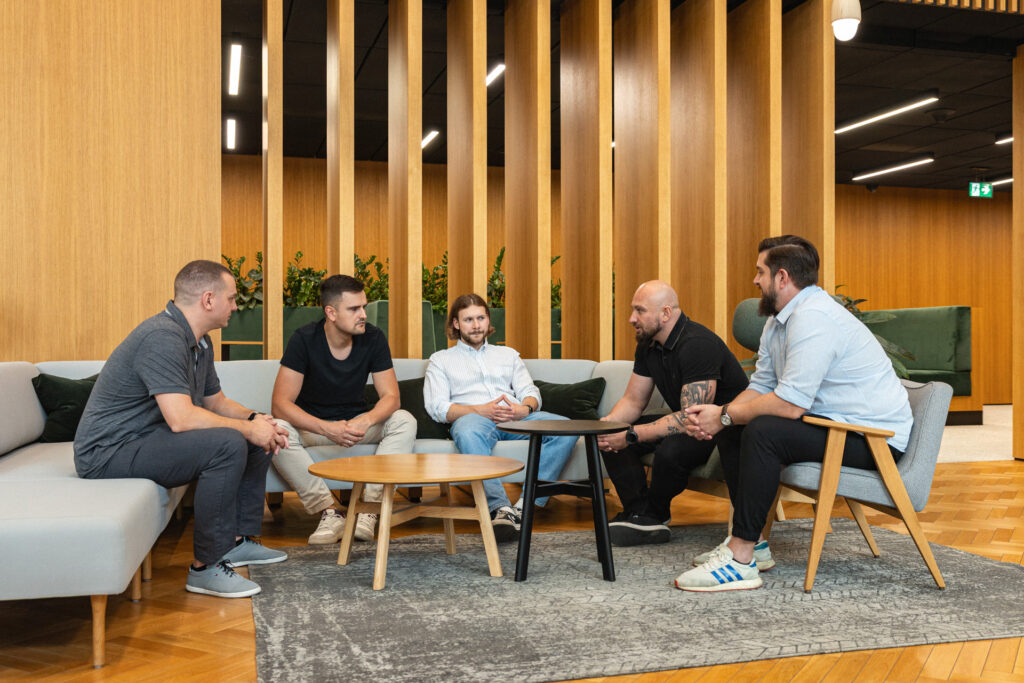 Spyrosoft AdTech employees sitting around a table