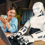 Robot and woman working on laptop in office