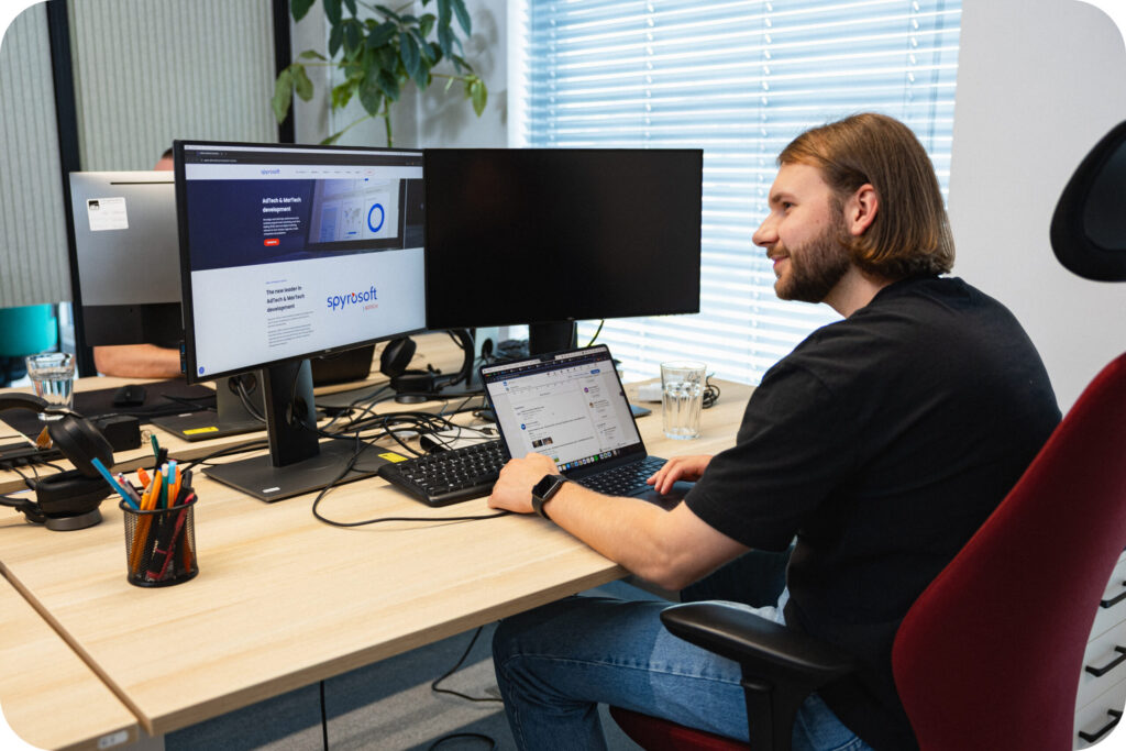 A Spyrosoft AdTech employee sitting in front of a computer
