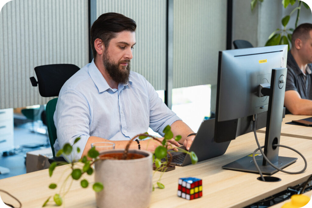 A Spyrosoft AdTech employee sitting in front of a computer.